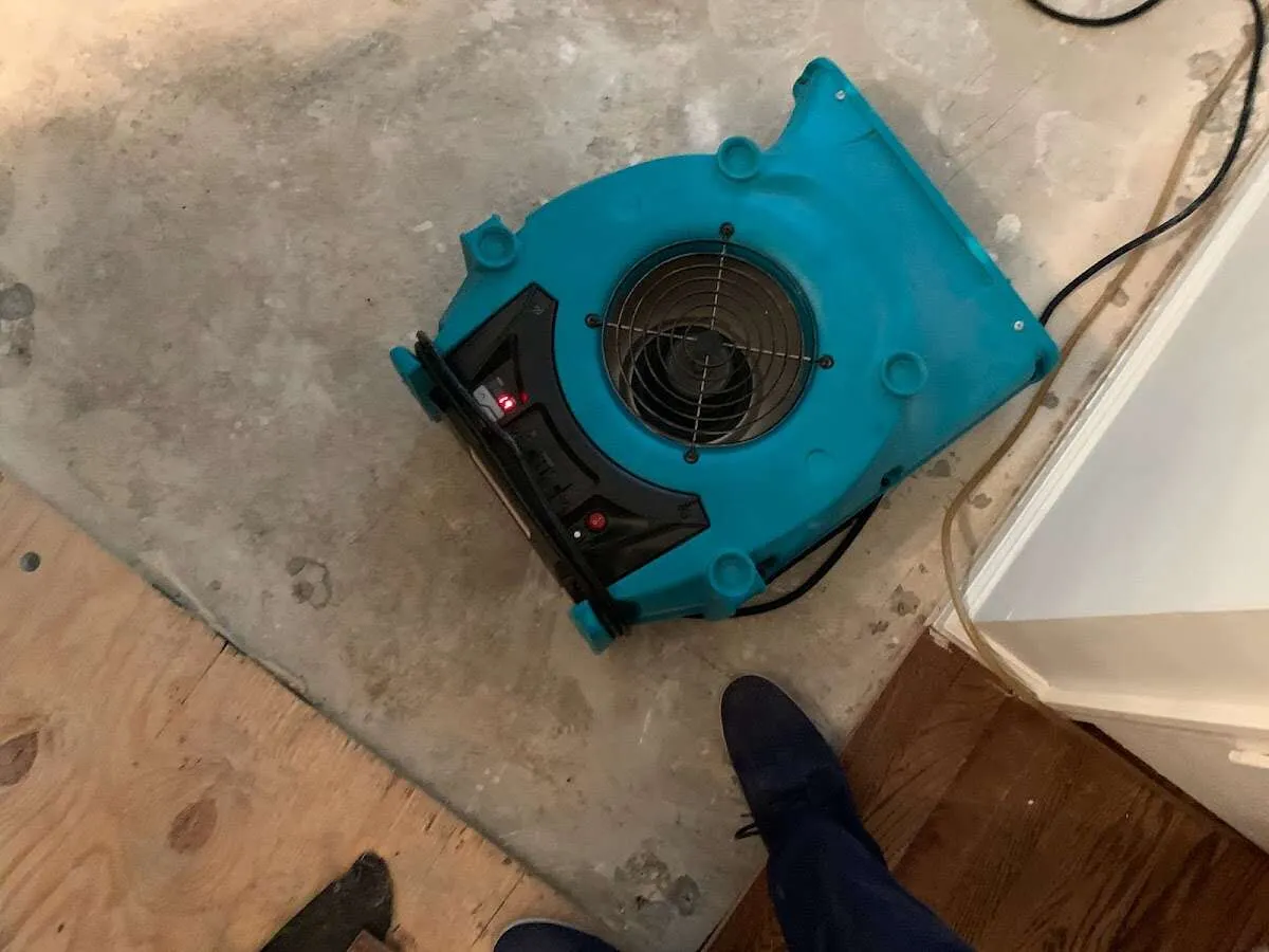 Air mover drying subfloor during Commercial Water Damage Restoration in Charlotte